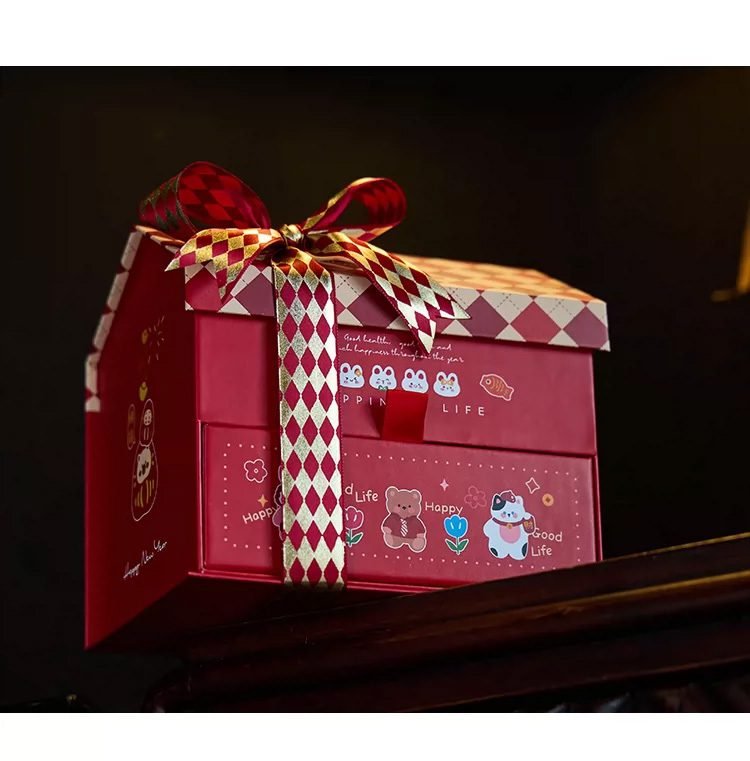 Red house-shaped box with nougat in the pull-out drawer